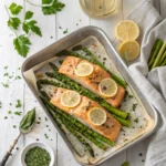 Baked salmon with asparagus on foil-lined sheet pan